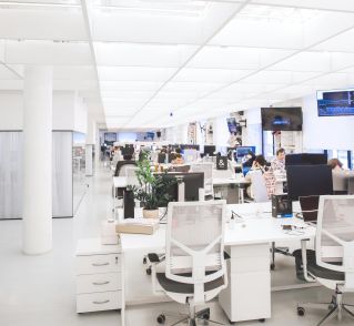 Spacious and well-lit office interior with modern furniture and workstations, ideal for a dynamic work environment.